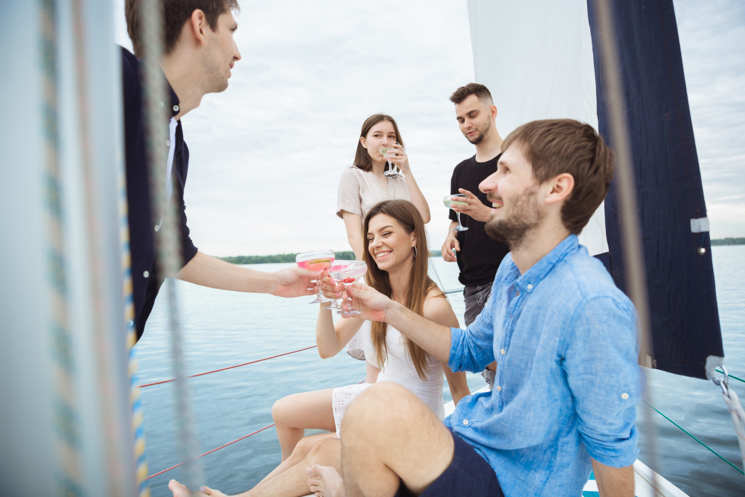 group-happy-friends-drinking-vodka-cocktails-boat